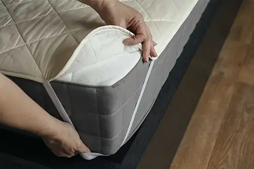 Person putting a mattress cover on a bed - Florida Pest Control, Gainesville FL